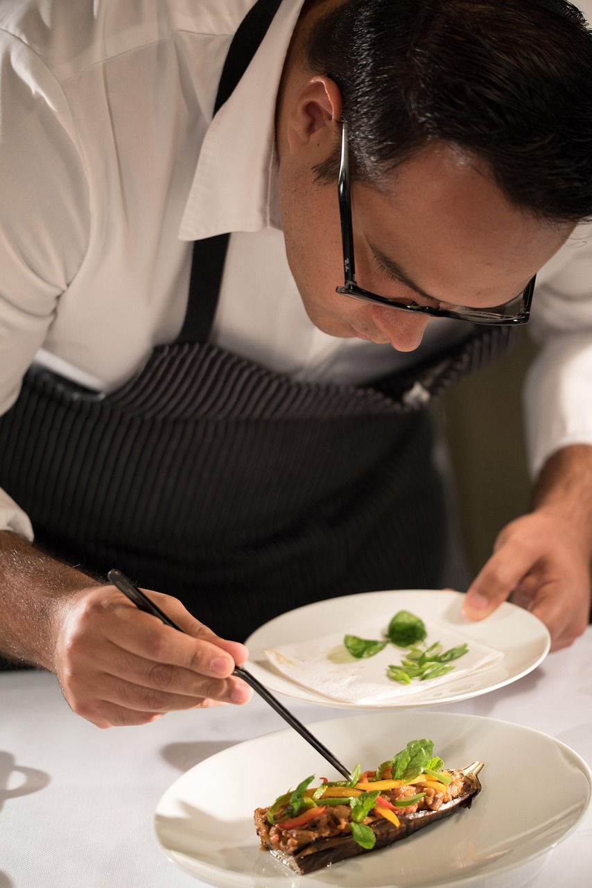 A chef carefully plating a fresh seasonal dish in the restaurant kitchen