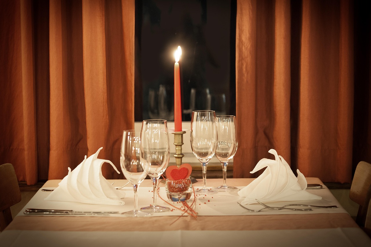 A candlelit table set for two in a cozy restaurant